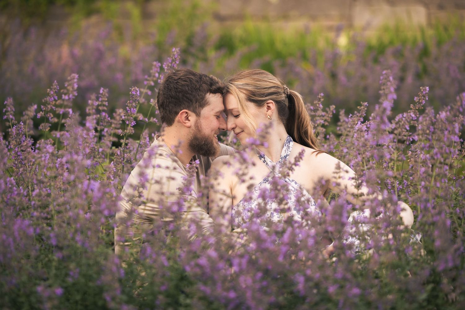 A tender moment captured in a field of blooming purple lavender flowers.