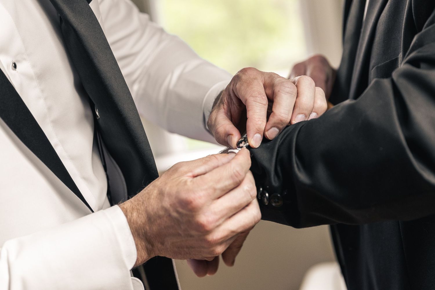 Detail shots of wedding rings being exchanged during ceremony.