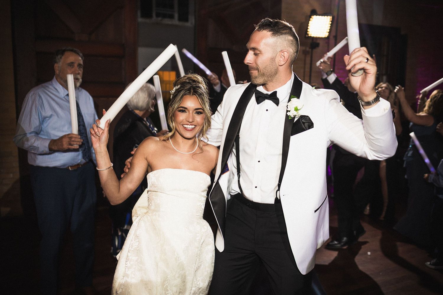Wedding couple dancing together during evening reception celebration.