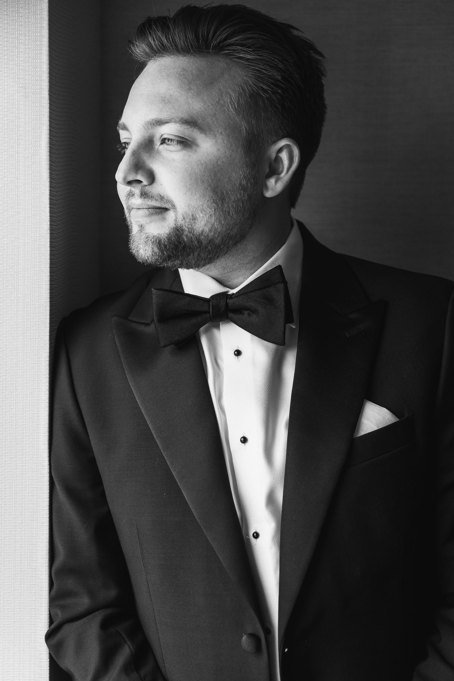 Classic black and white portraits of groom in tuxedo showing various angles.