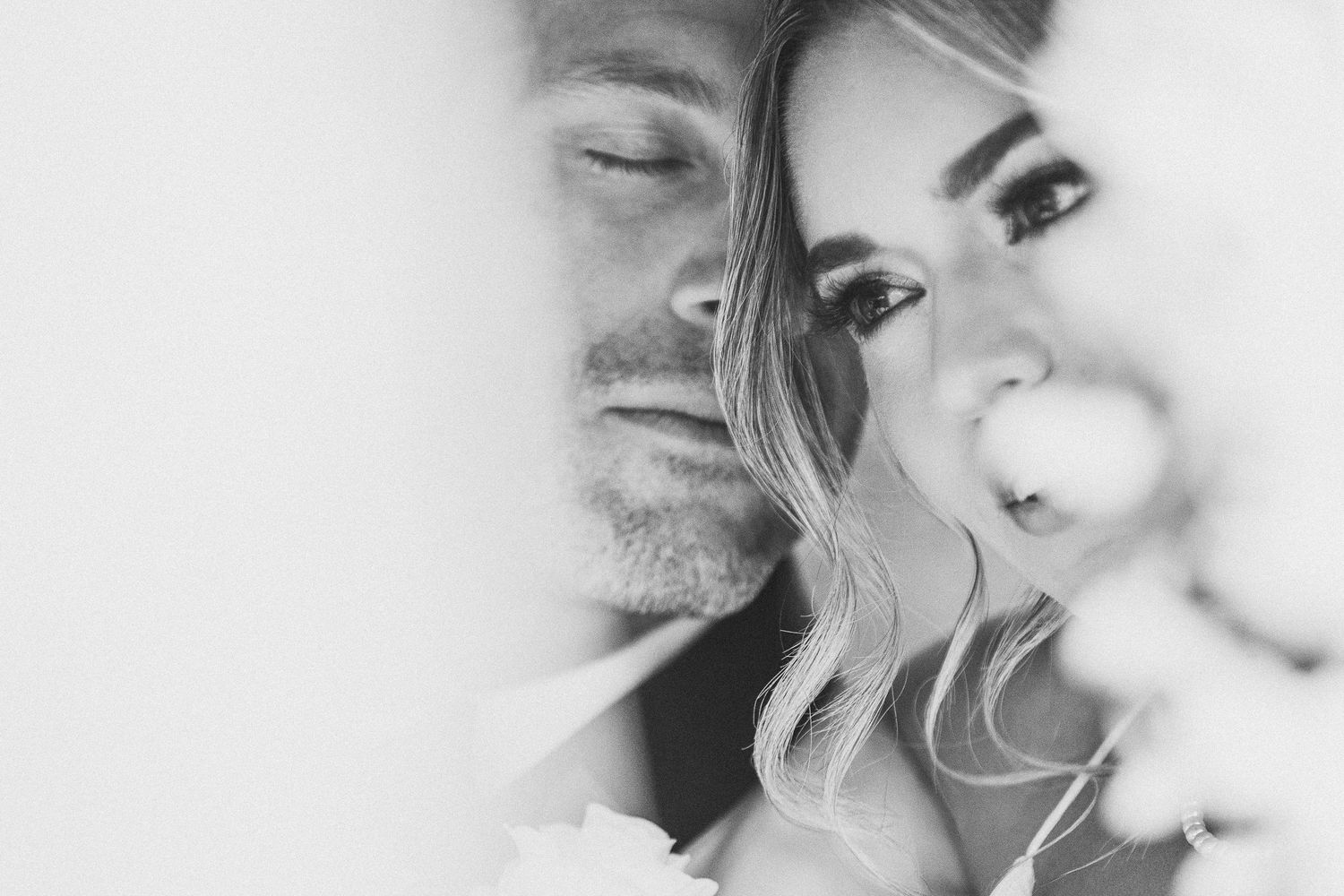 Soft focus black and white romantic wedding portrait with dreamy ethereal lighting.
