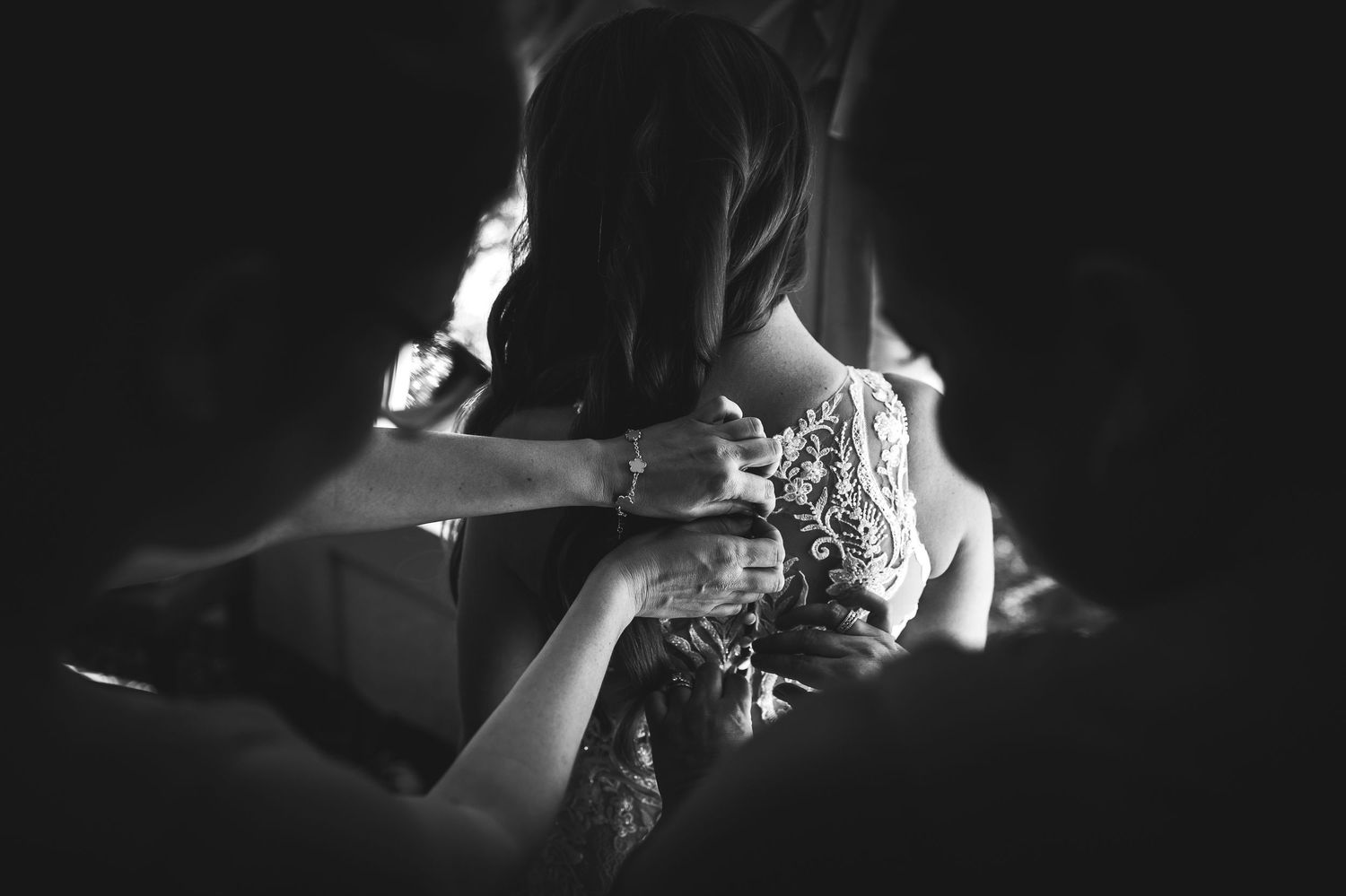 Artistic black and white detail shots of wedding dress and accessories.