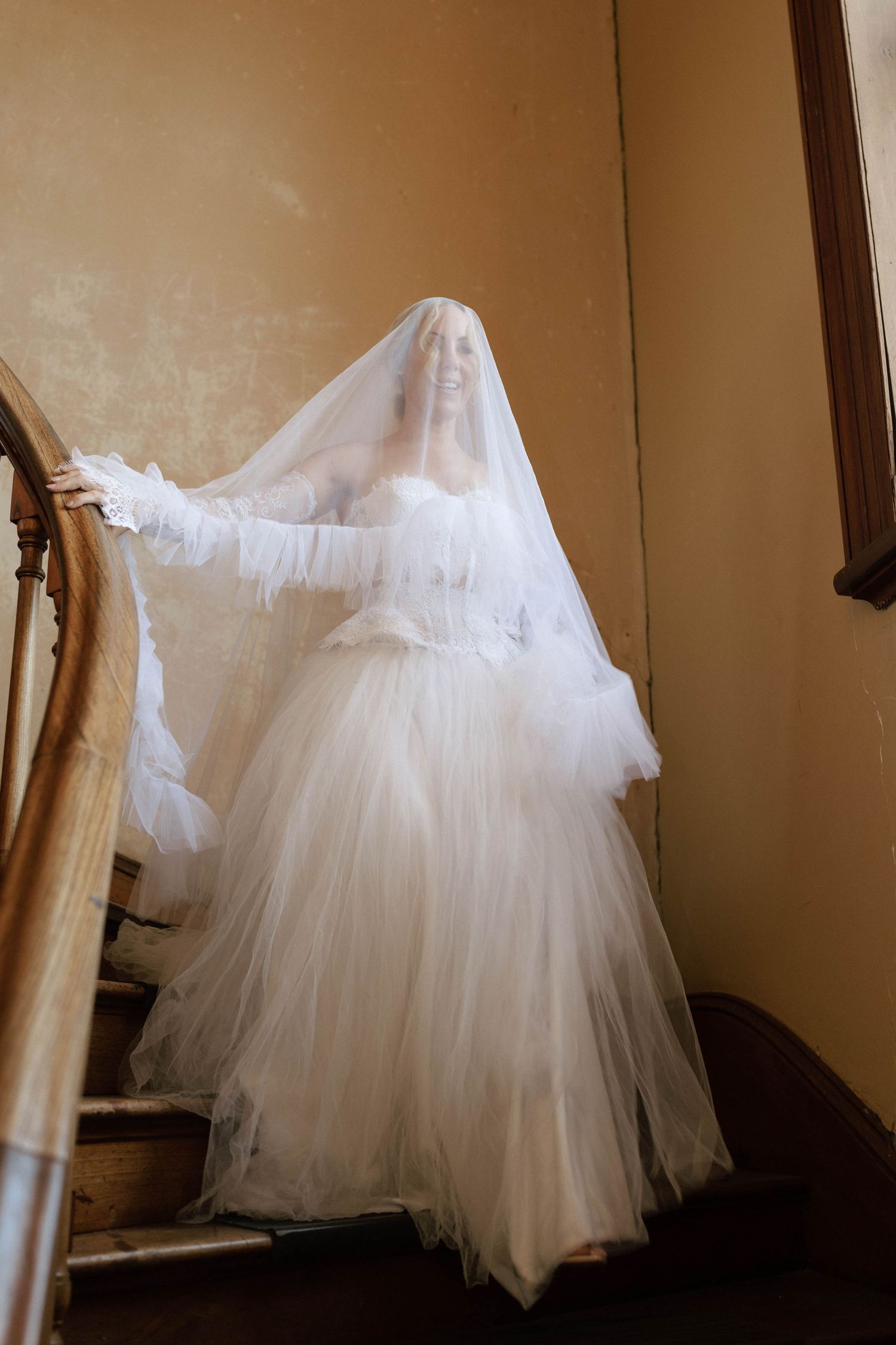 A flowing white tulle wedding dress skirt twirls in a series of four sequential motion shots.