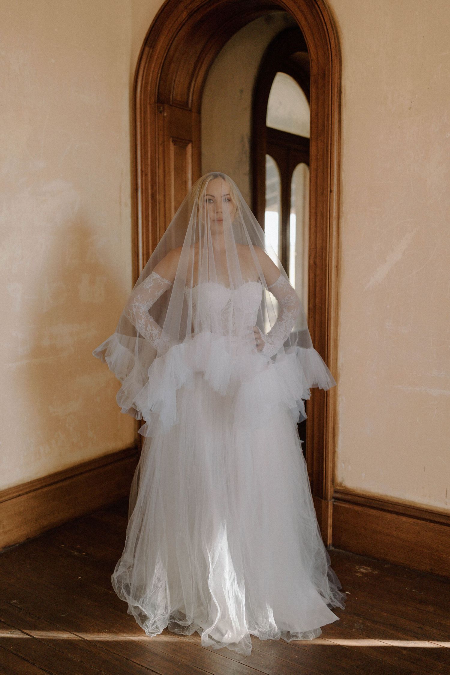 A haunting sequence shows a ghostly figure in a white wedding dress and veil moving through a dimly lit hallway.