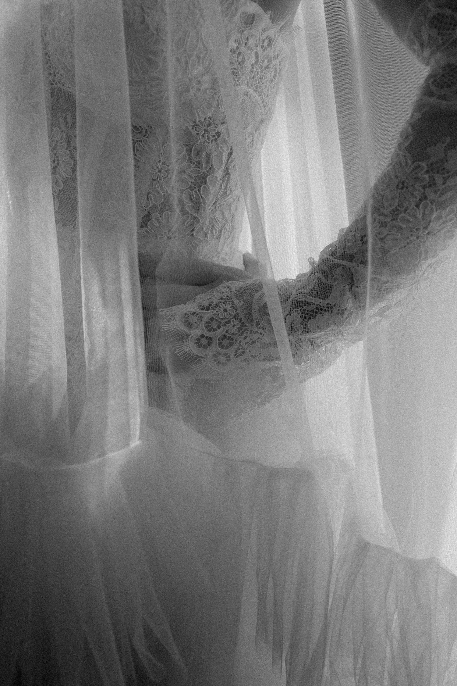 Ethereal white curtains and sheer fabric panels create a dreamy, light-filled atmosphere in a window display.