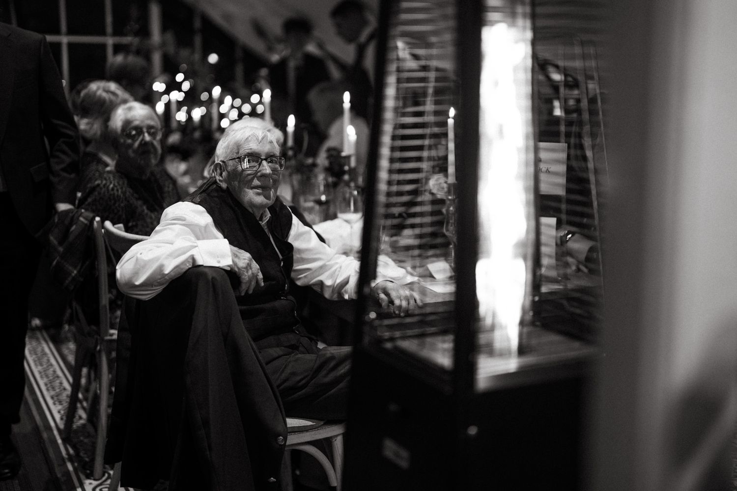 Black and white photo captures intimate moments during an evening wedding reception.