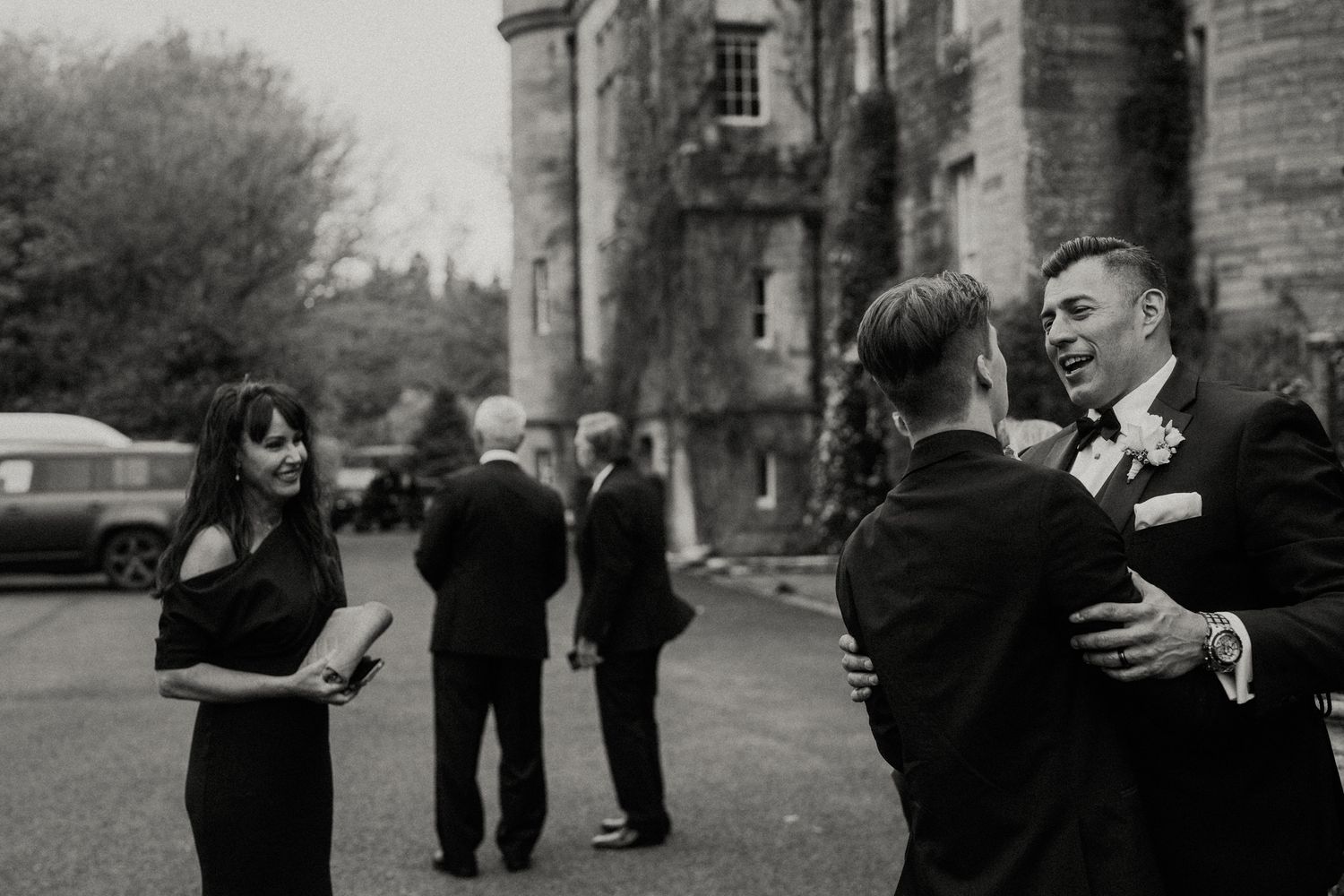Black and white candid moments of wedding party interactions outdoors.