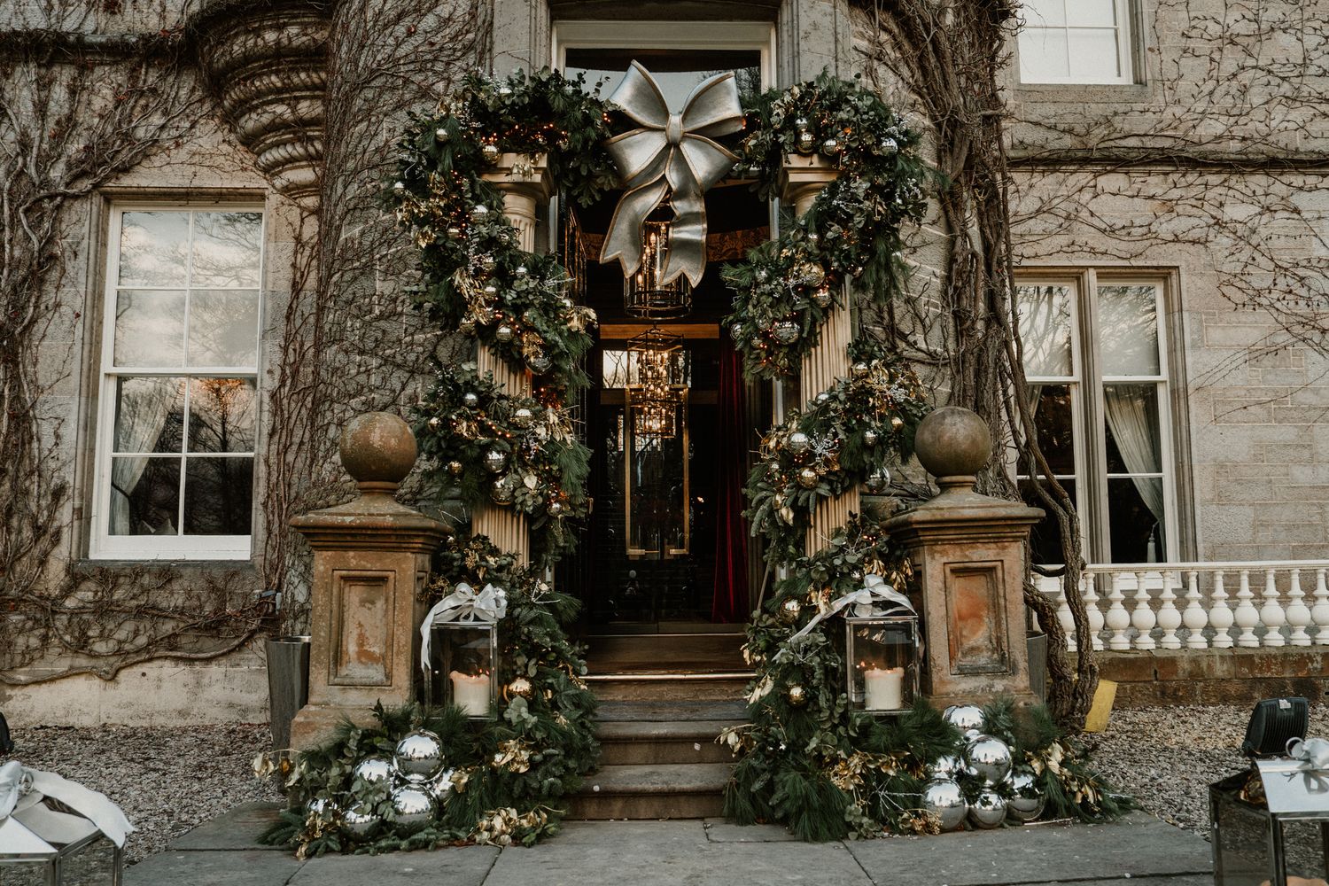 Stone facade of an elegant wedding venue with climbing vines and classic architecture.
