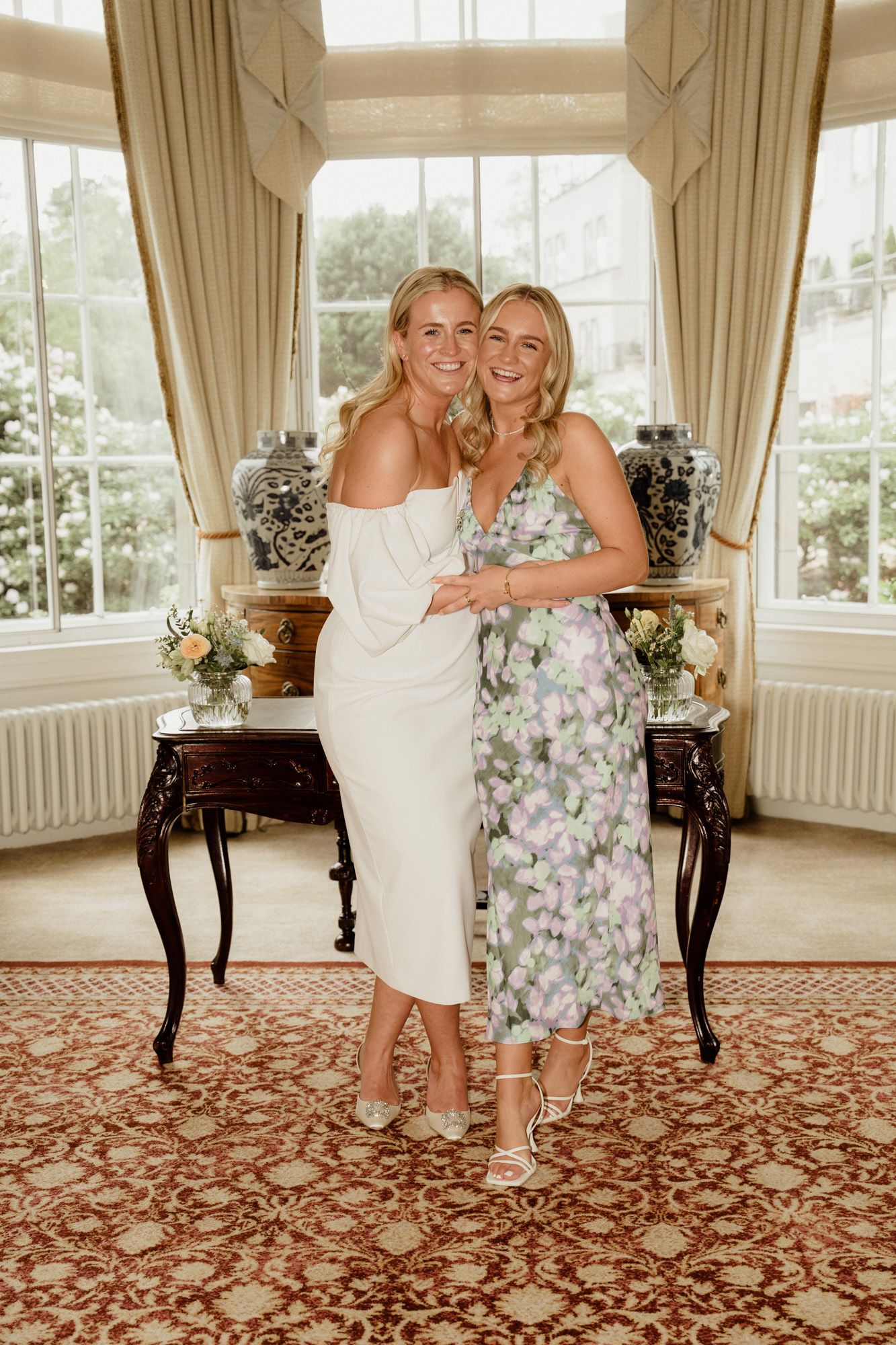 Wedding celebration in a bright room with patterned carpet and antique furniture.