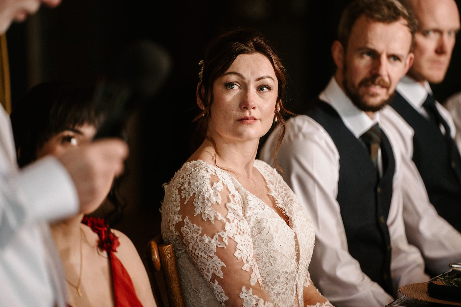 Wedding ceremony guests seated in rows during an indoor celebration.