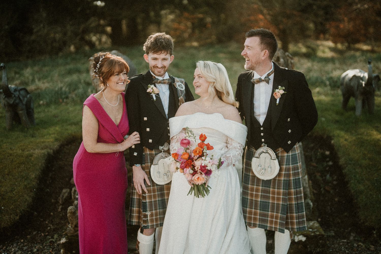 Wedding party members gather outdoors for casual candid photos.