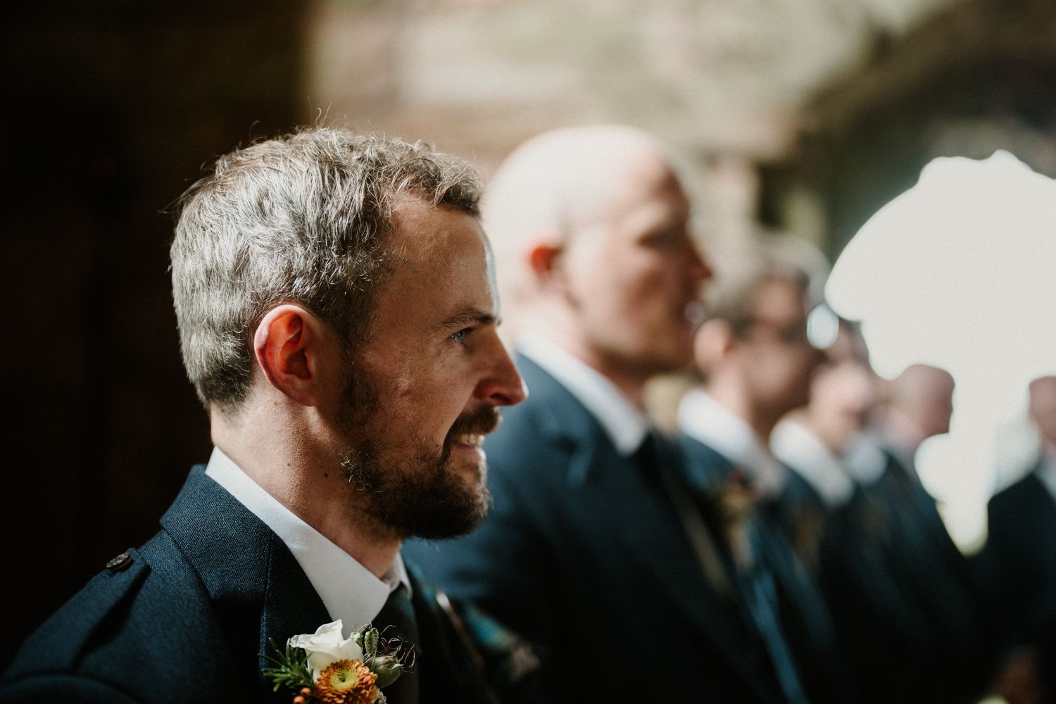 Candid wedding moments captured in dramatic church lighting and architecture.