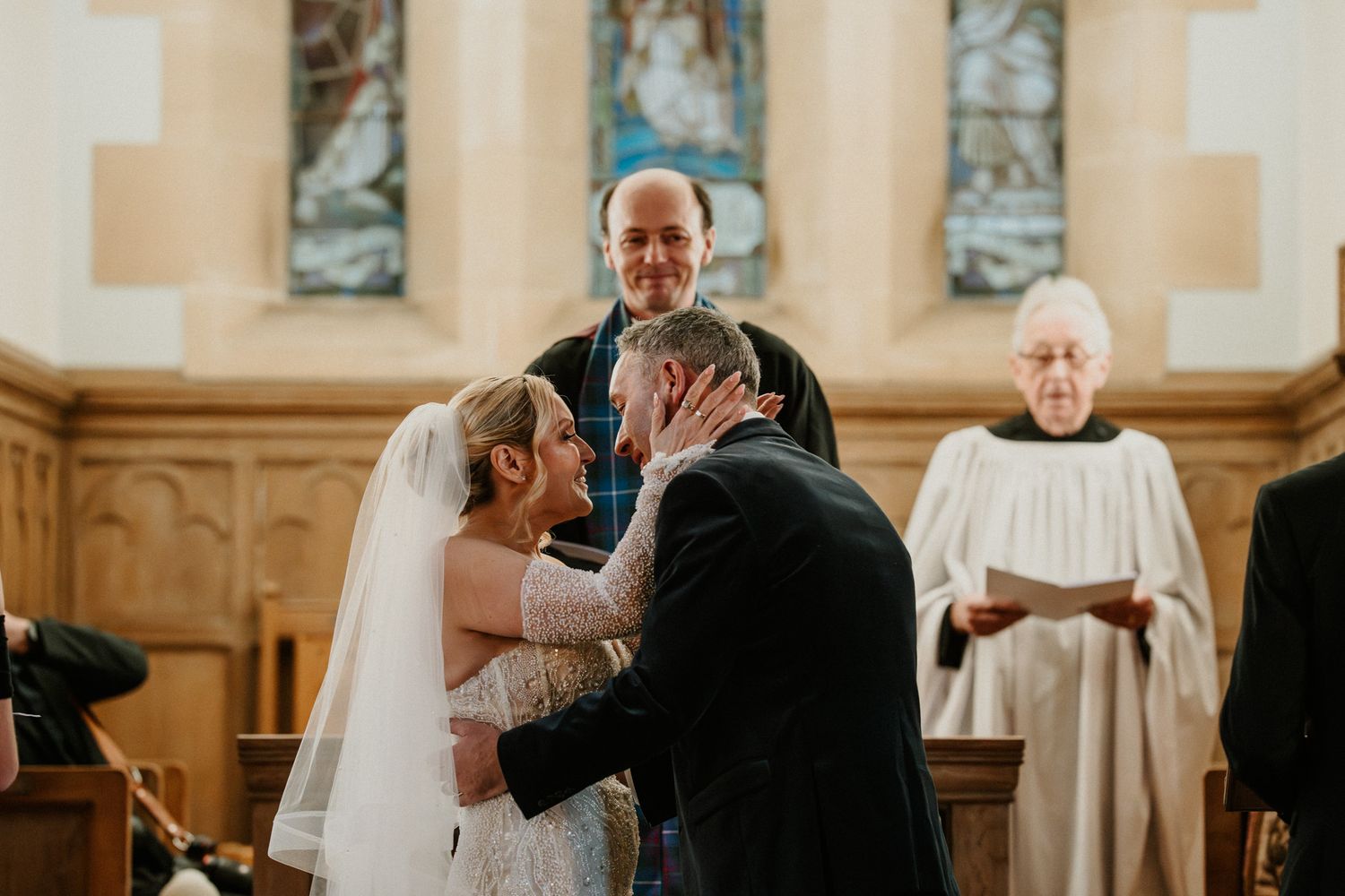 Wedding ceremony taking place in a grand traditional church interior.