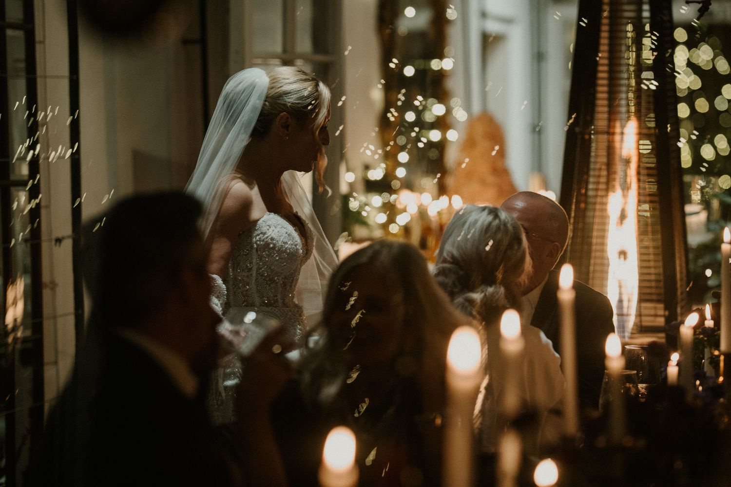 Candlelit wedding reception venue with twinkling lights and greenery creating a romantic atmosphere.