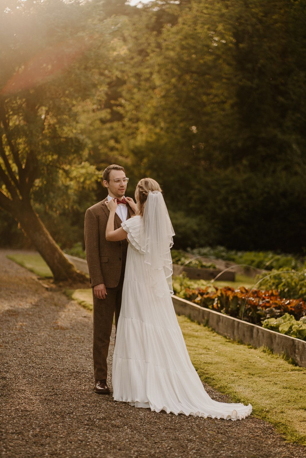 Golden hour wedding portraits in a garden setting with beautiful natural light.