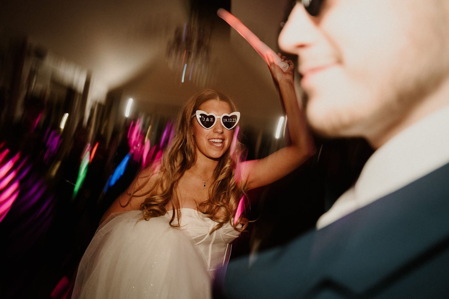 Party scene with sunglasses and festive lighting creating an energetic atmosphere.
