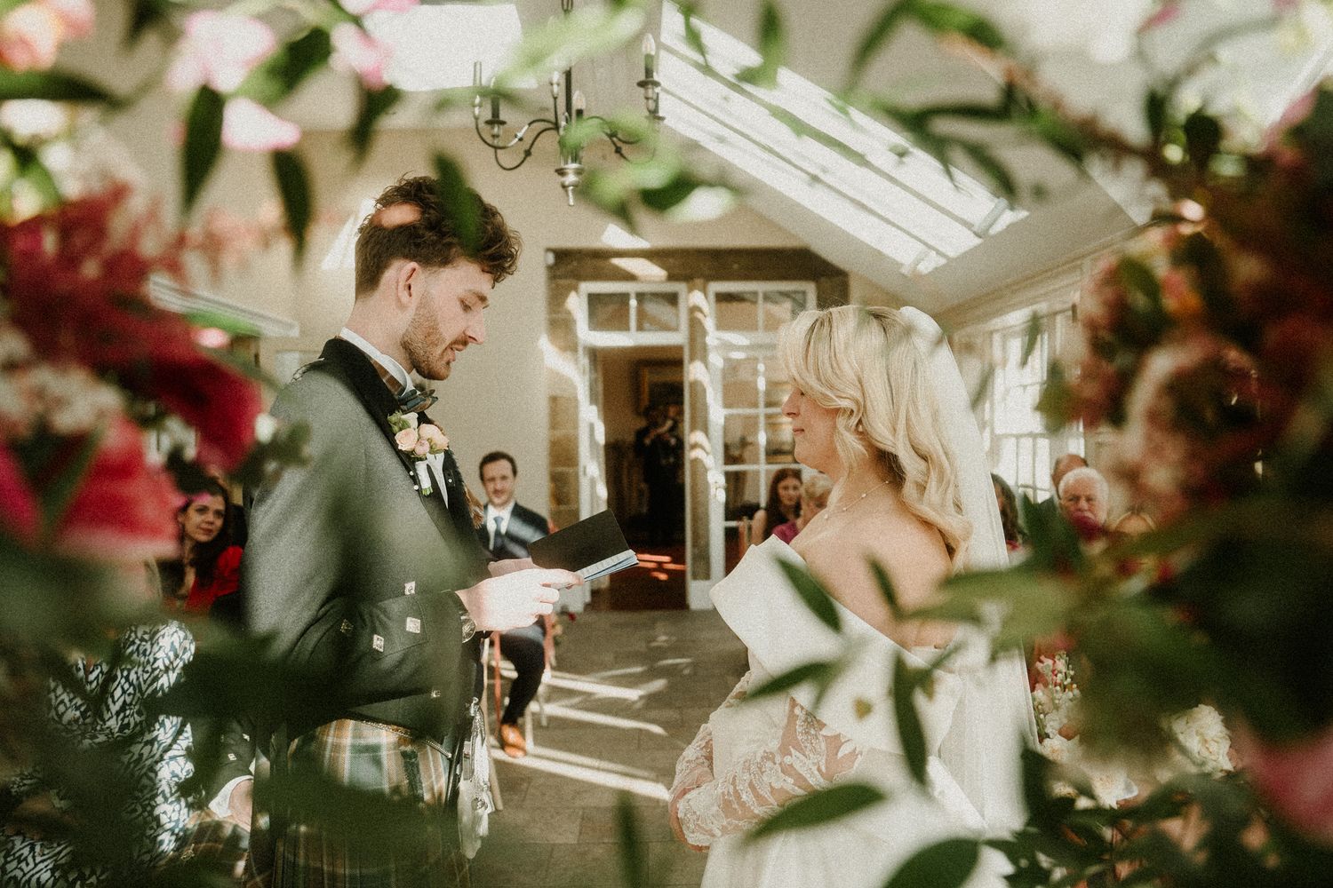 Wedding venue interior with soft lighting and floral decorations.