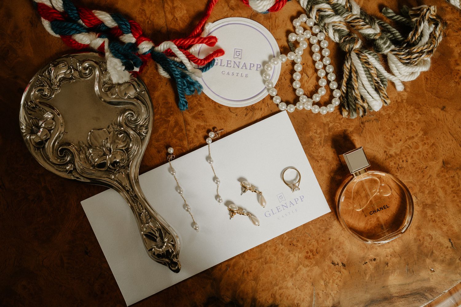 Wedding details including invitations and decorative elements on textured surface.