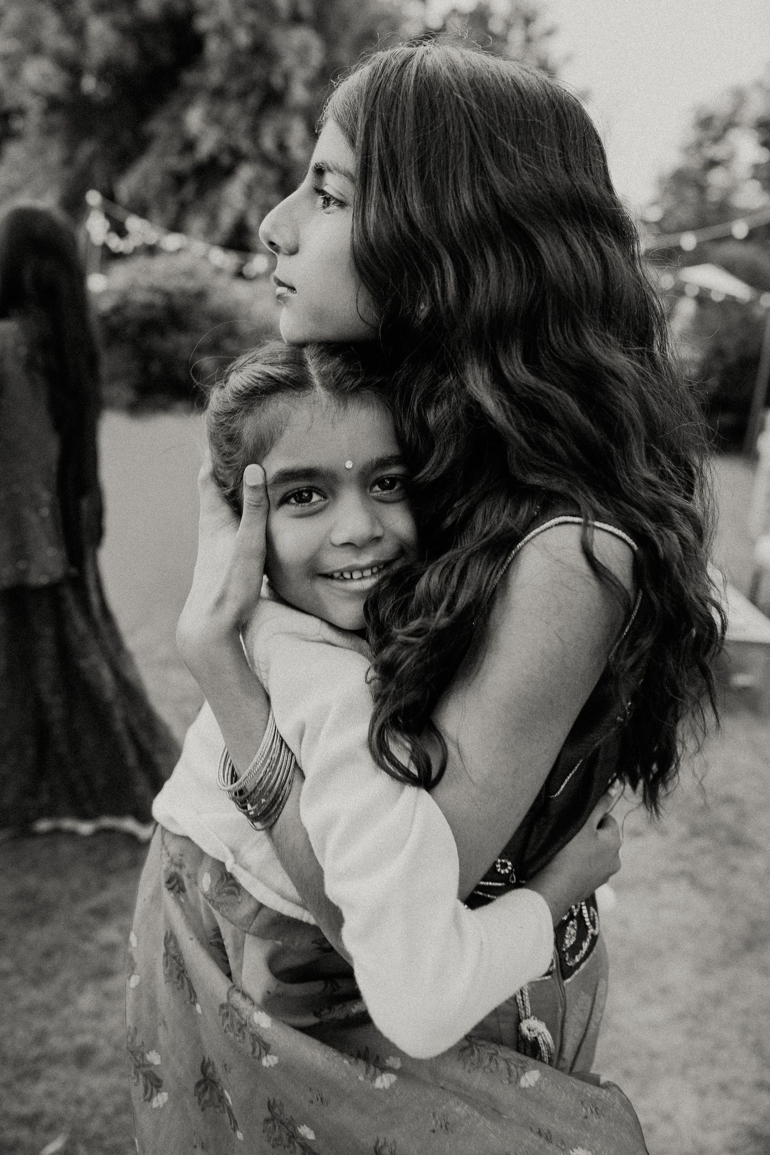 Sweet candid black and white portraits captured in an outdoor setting showing joyful expressions and natural moments.