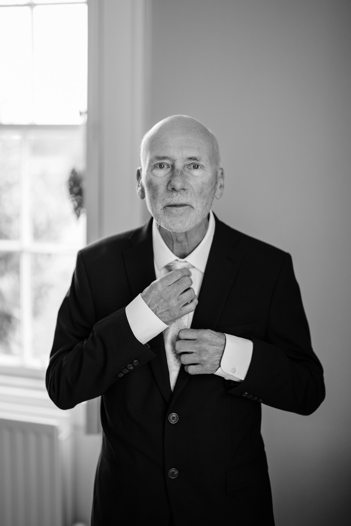 Black and white portrait series showing expressive gestures in formal attire.