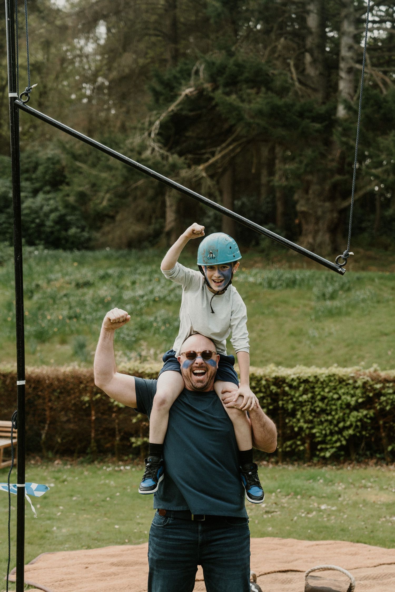 A joyful moment captured as two people celebrate near outdoor sports equipment.