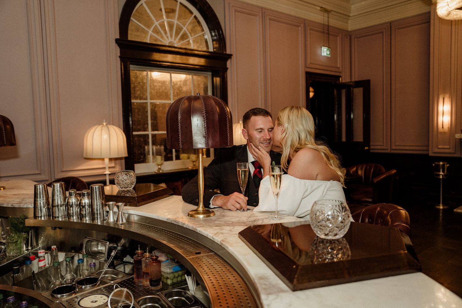 Elegant dining room interior with crystal chandeliers and classic decor at a formal event venue.