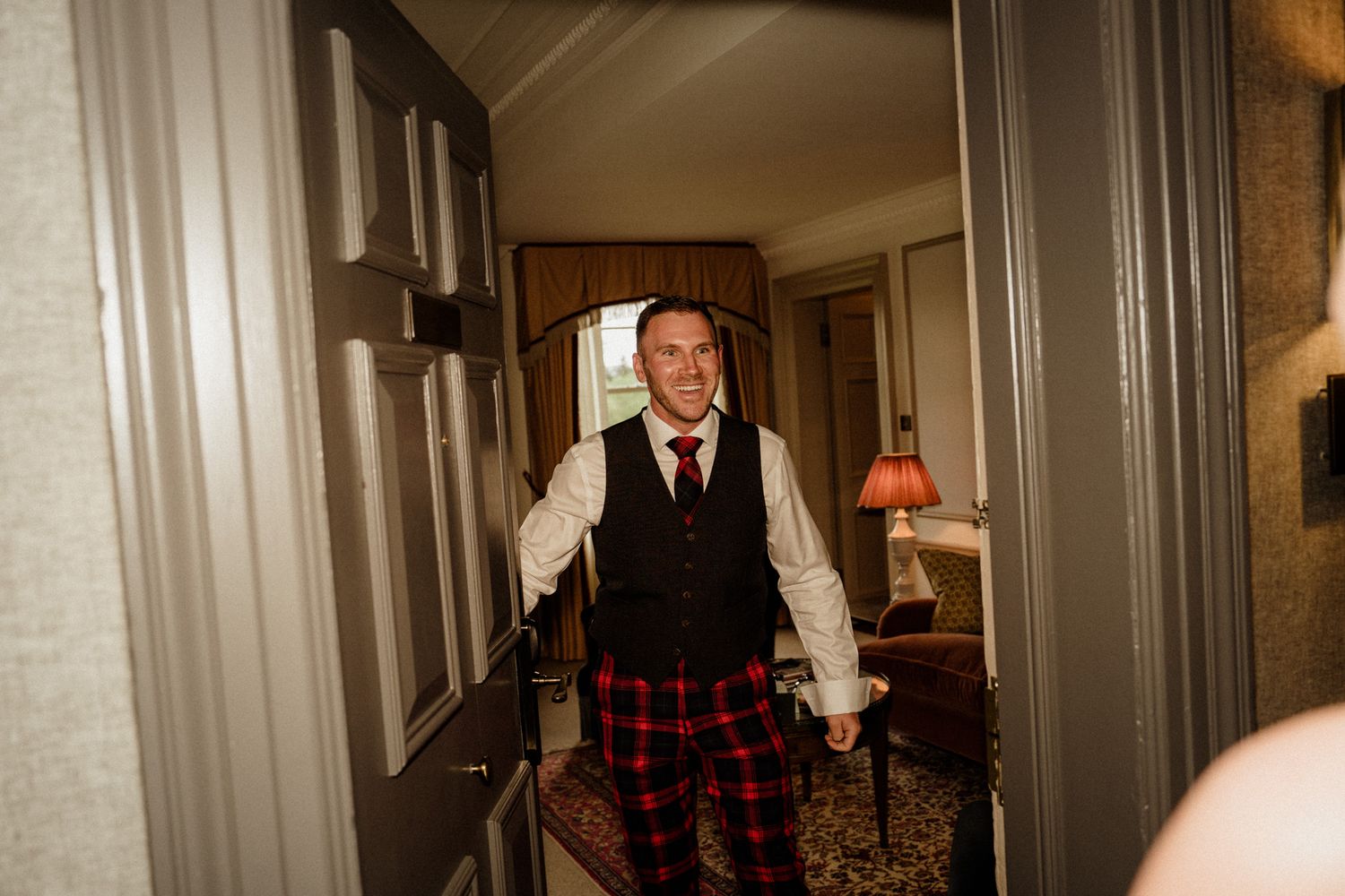 Wedding party preparations in a luxurious hotel room with warm lighting.