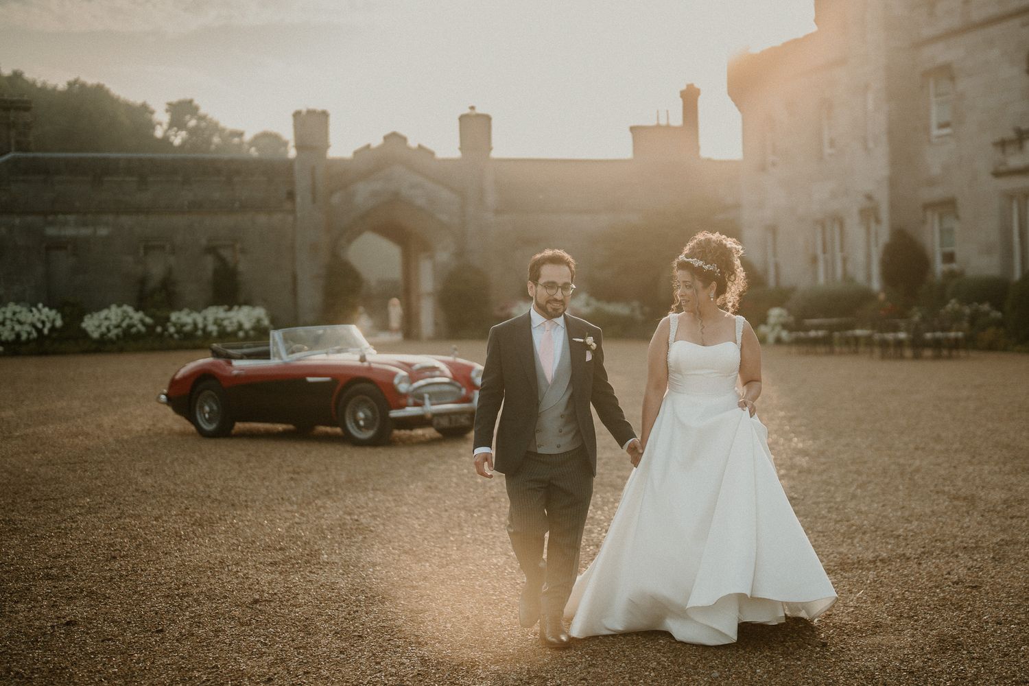 Sunset wedding portraits captured on the grounds of a magnificent stone castle estate.