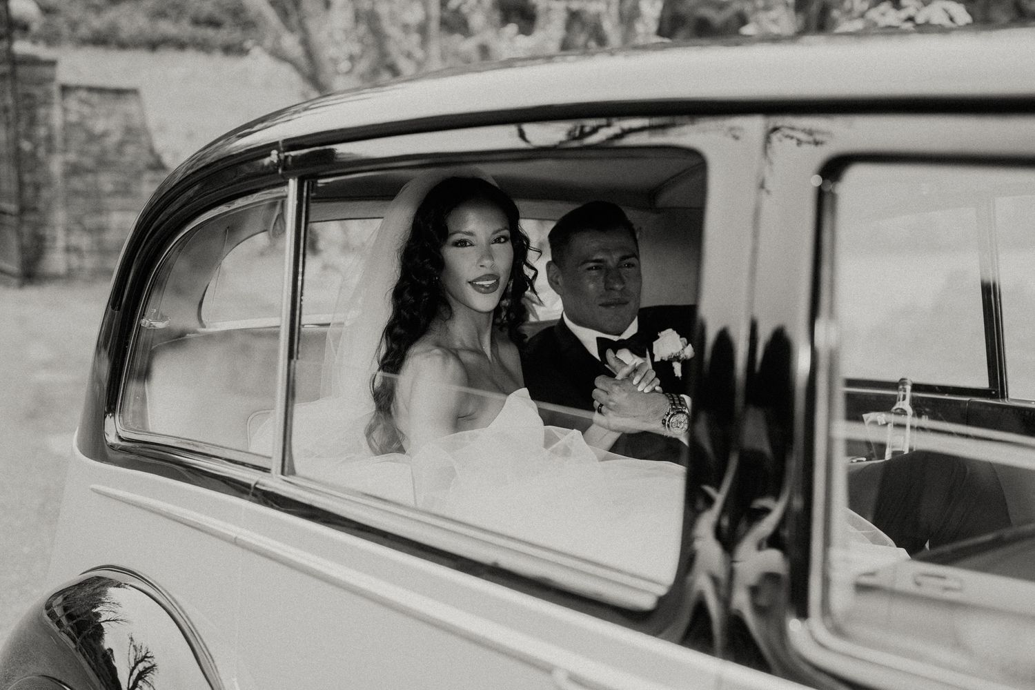 Romantic wedding transportation in elegant vintage car with classic details.