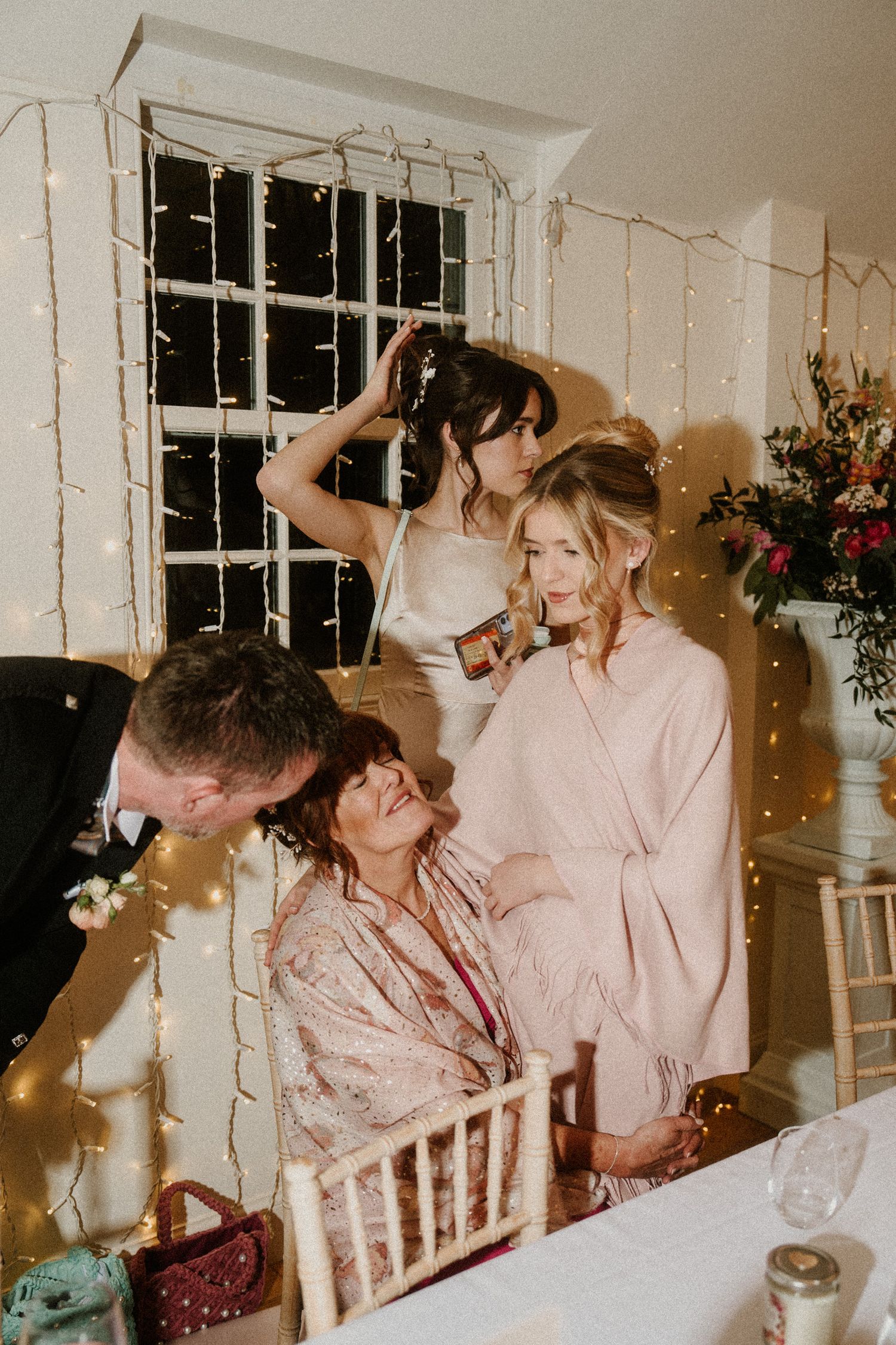 Wedding party celebration with string lights and joyful moments captured in warm tones.