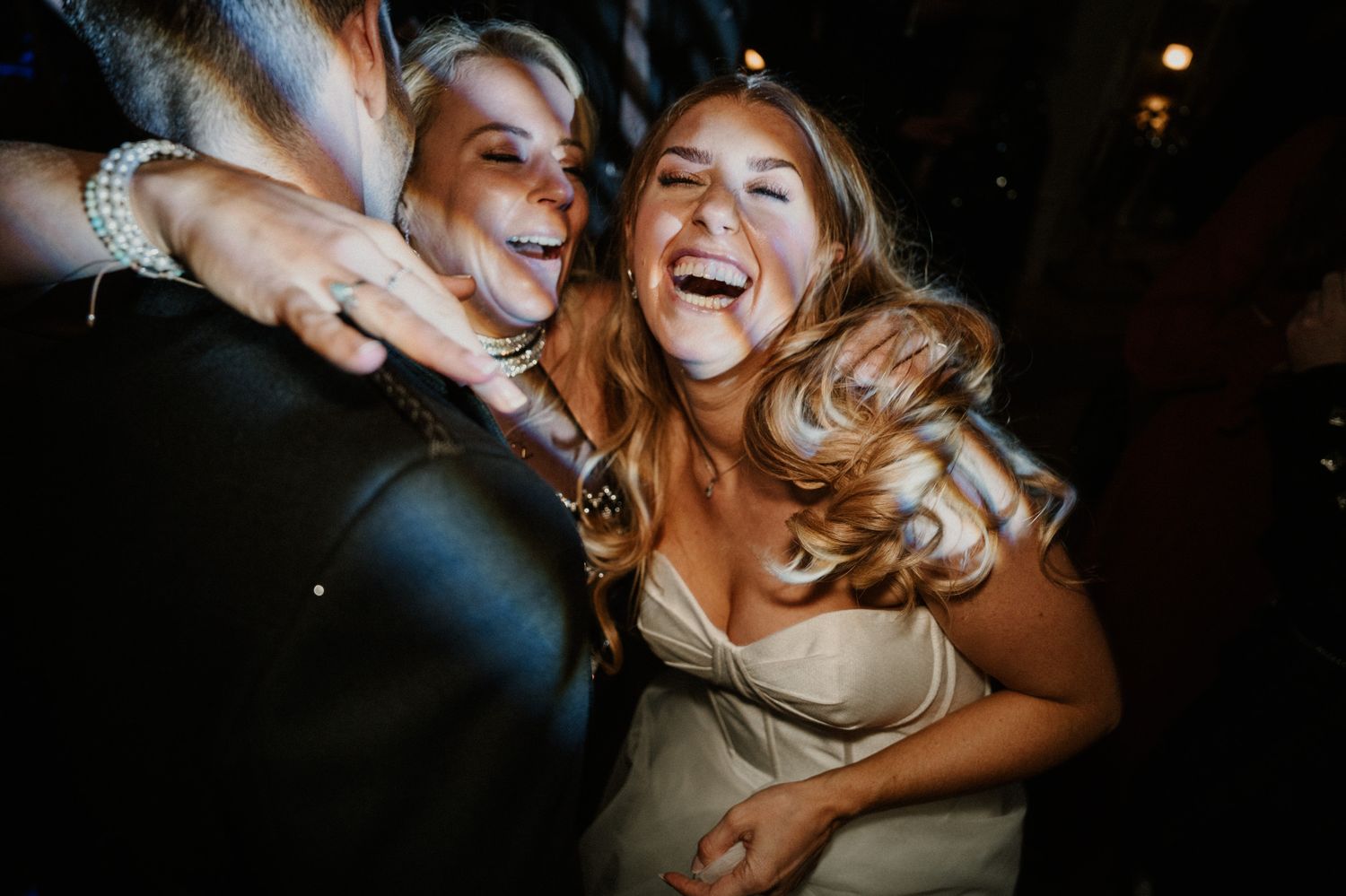 Close-up shot of joyful party moments captured under dramatic event lighting.
