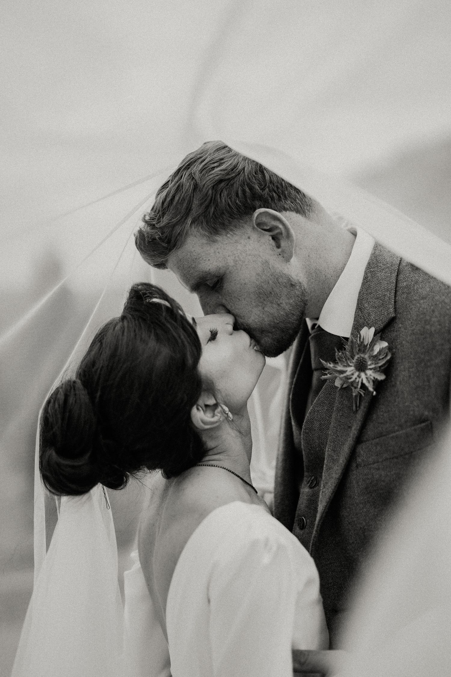 Romantic black and white portrait of newlyweds sharing an intimate moment.