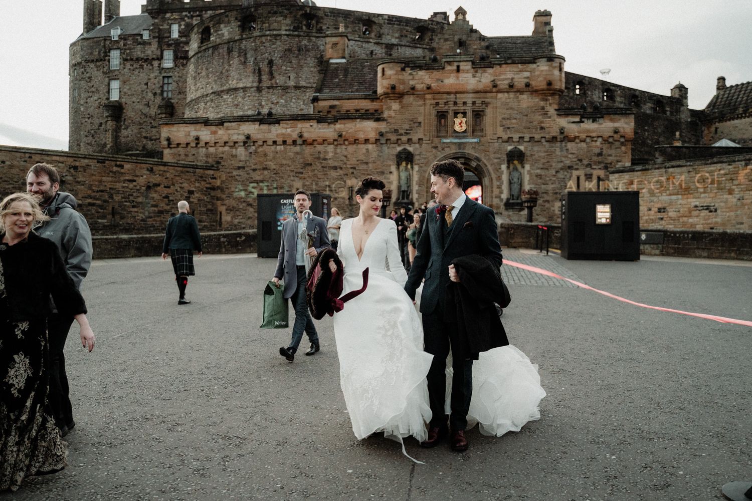 Wedding party gathering in the courtyard of a historic castle.