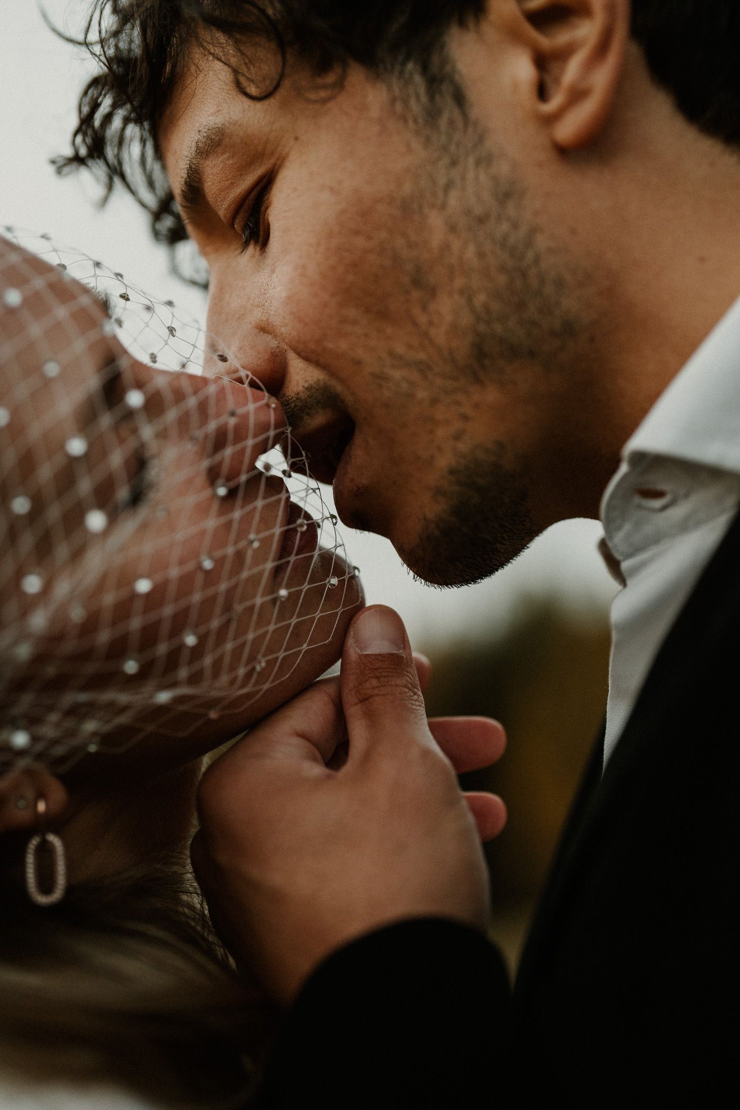 Artistic close-up wedding photograph showing intimate details and emotions.
