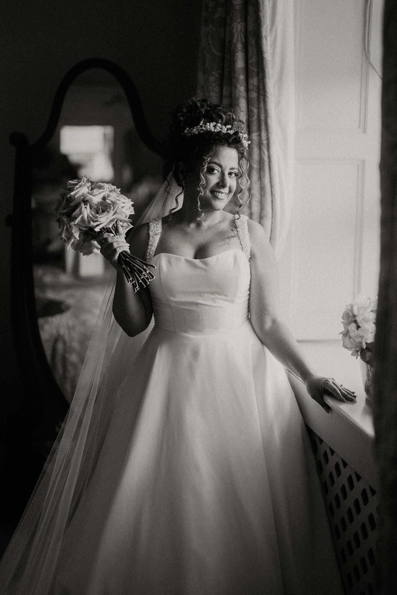 Ethereal bridal portraits captured in soft window light showing details of white wedding gown.