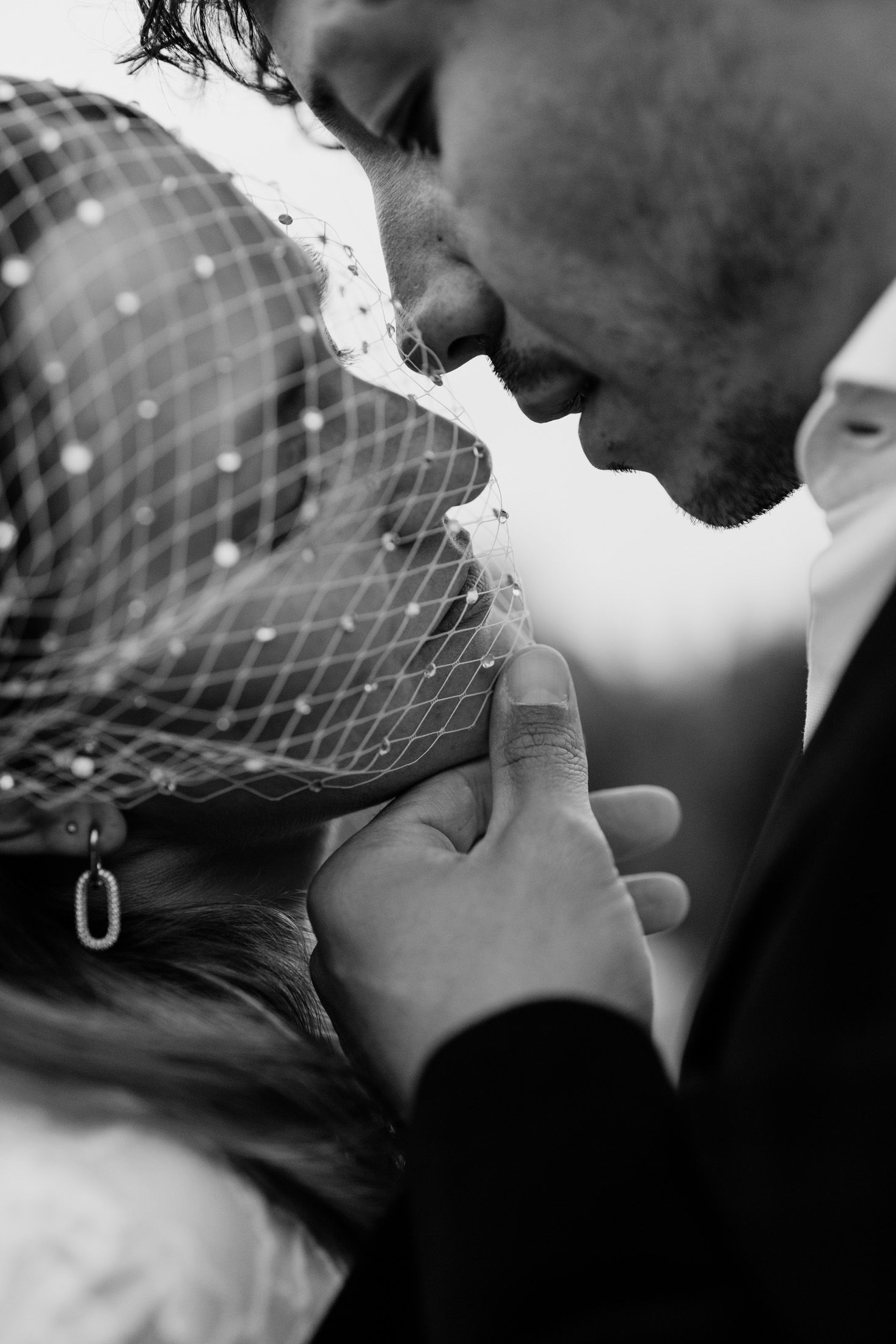 Black and white intimate portrait capturing a tender moment between newlyweds.
