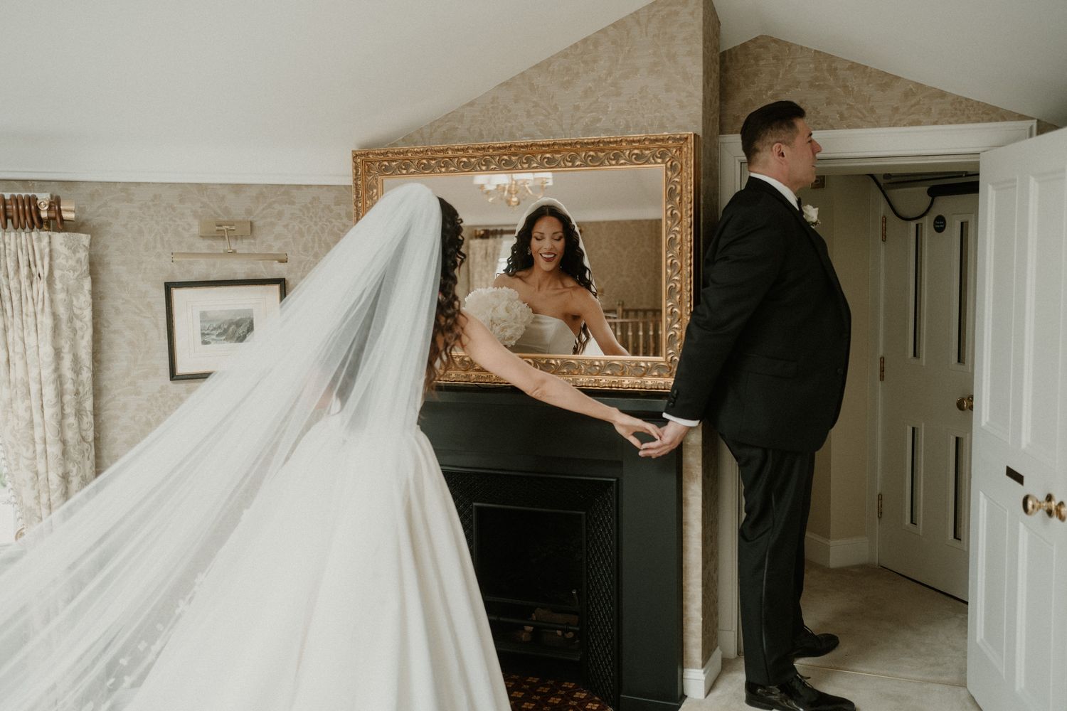 Wedding preparation scene with formal attire and flowing white dress in a classic interior.
