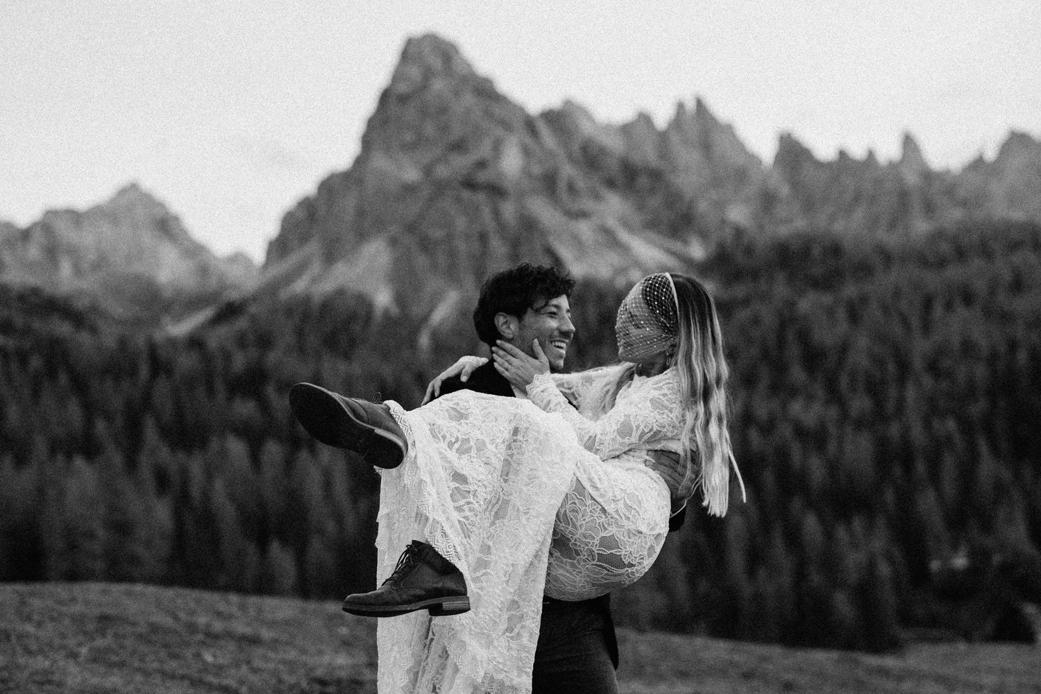 Joyful dance moment captured against dramatic Dolomite peaks and autumn scenery.