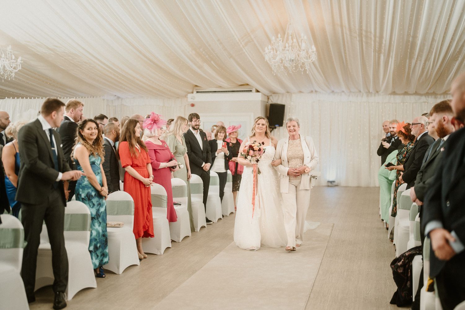Wedding ceremony venue with white draped ceiling and rows of chairs for guests.