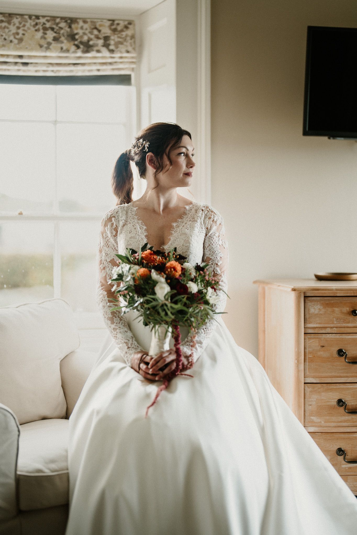 Elegant bridal portrait series featuring a white gown and colorful floral bouquet.