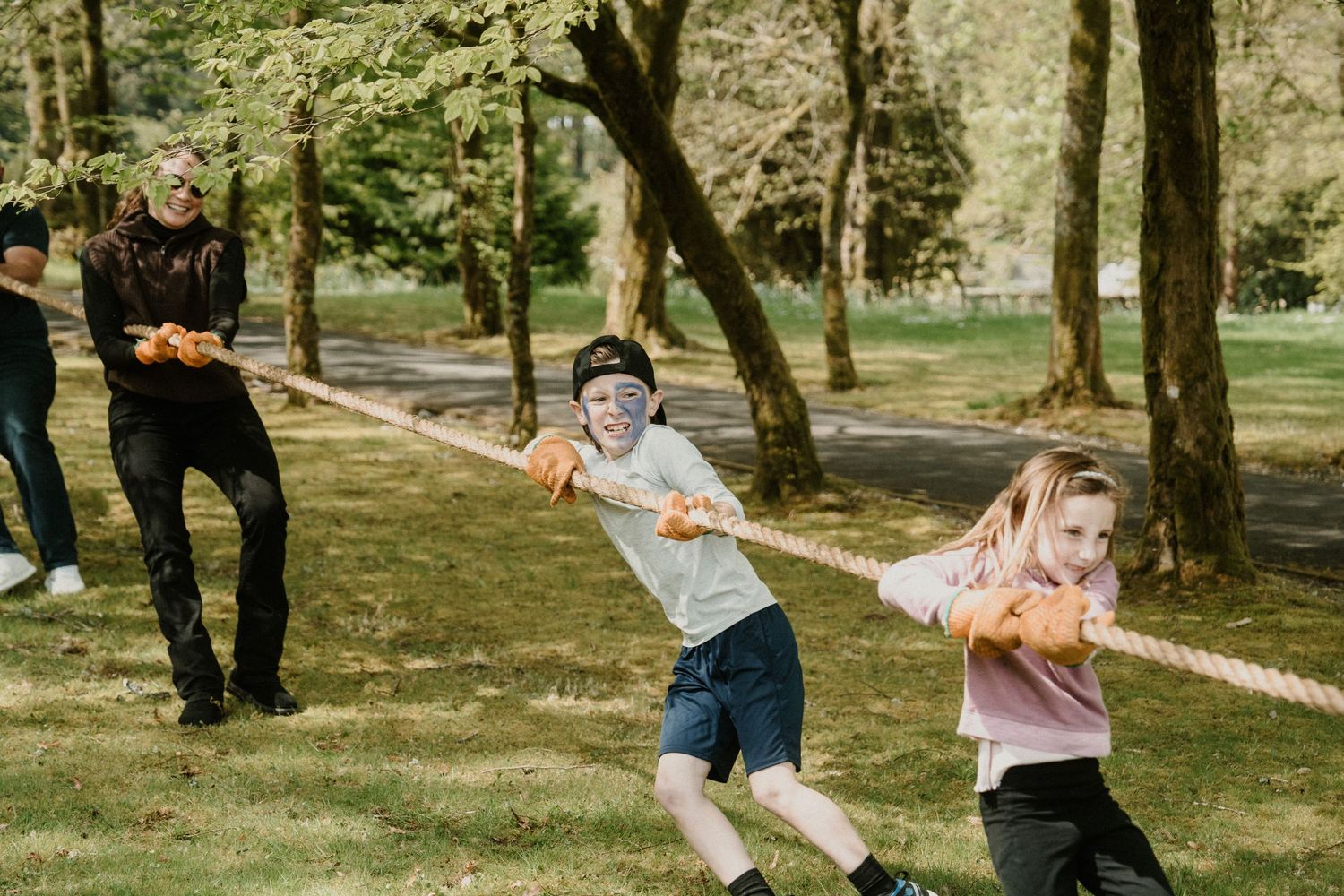 Group playing lawn games and having fun at an outdoor celebration.