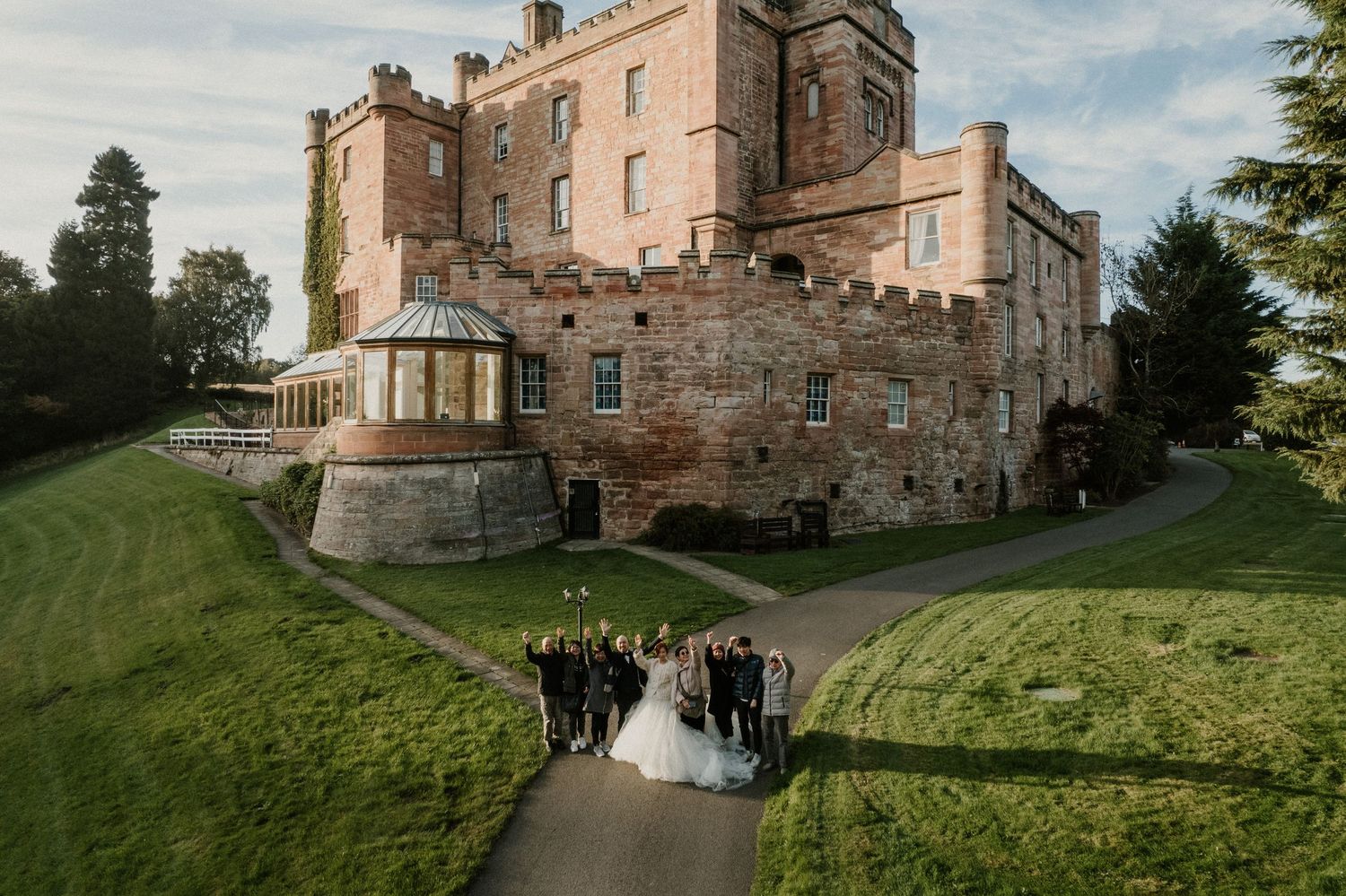A beautiful stone castle wedding venue with manicured grounds and pathways.