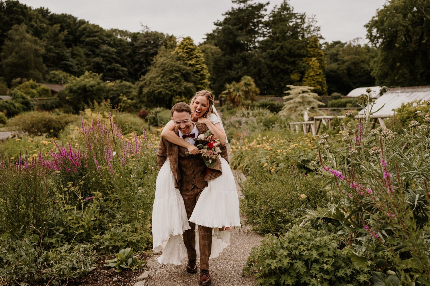 A romantic garden wedding scene with lush greenery and colorful wildflowers in bloom.