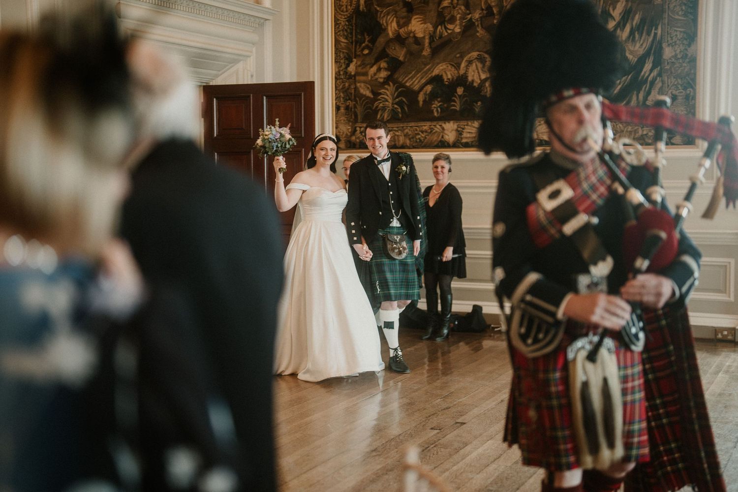 Wedding celebration with traditional Scottish music and dancing in an ornate indoor venue.