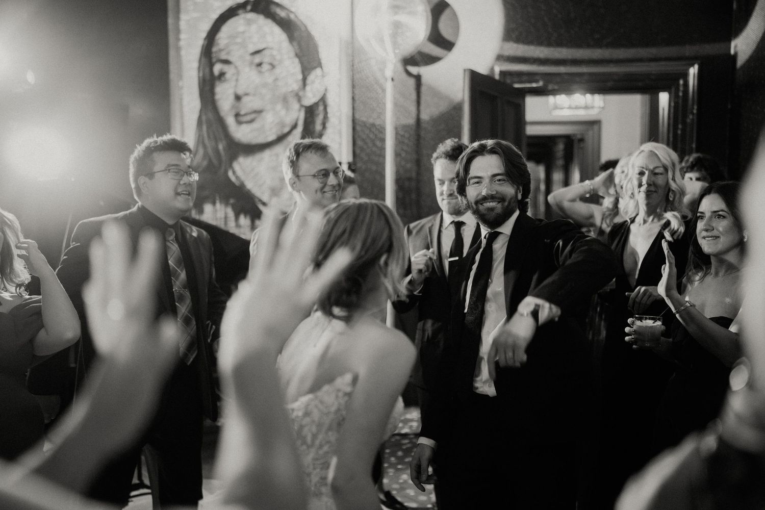 Black and white reception photos showing guests dancing and celebrating.