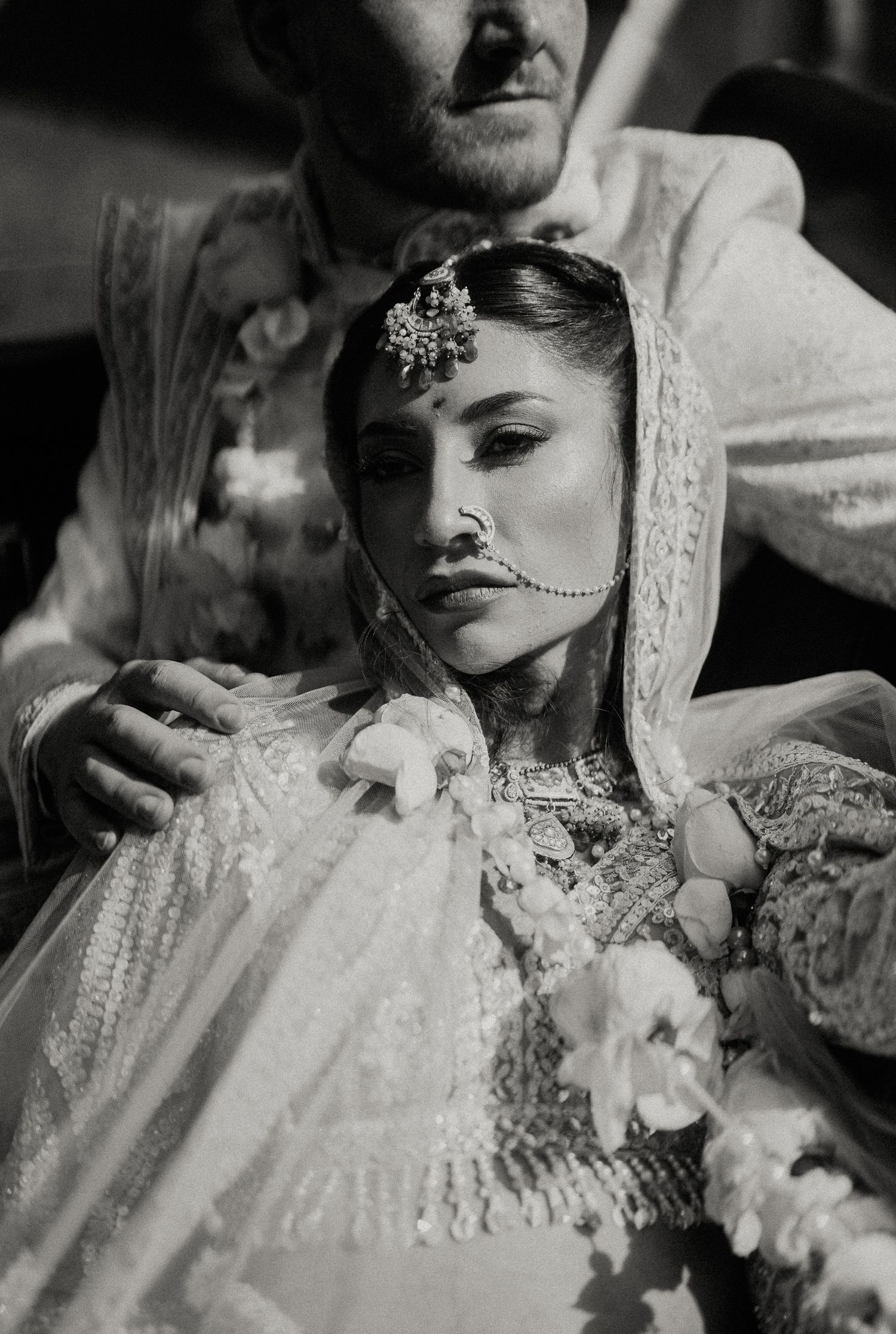 Black and white artistic wedding portrait with intricate lace details.