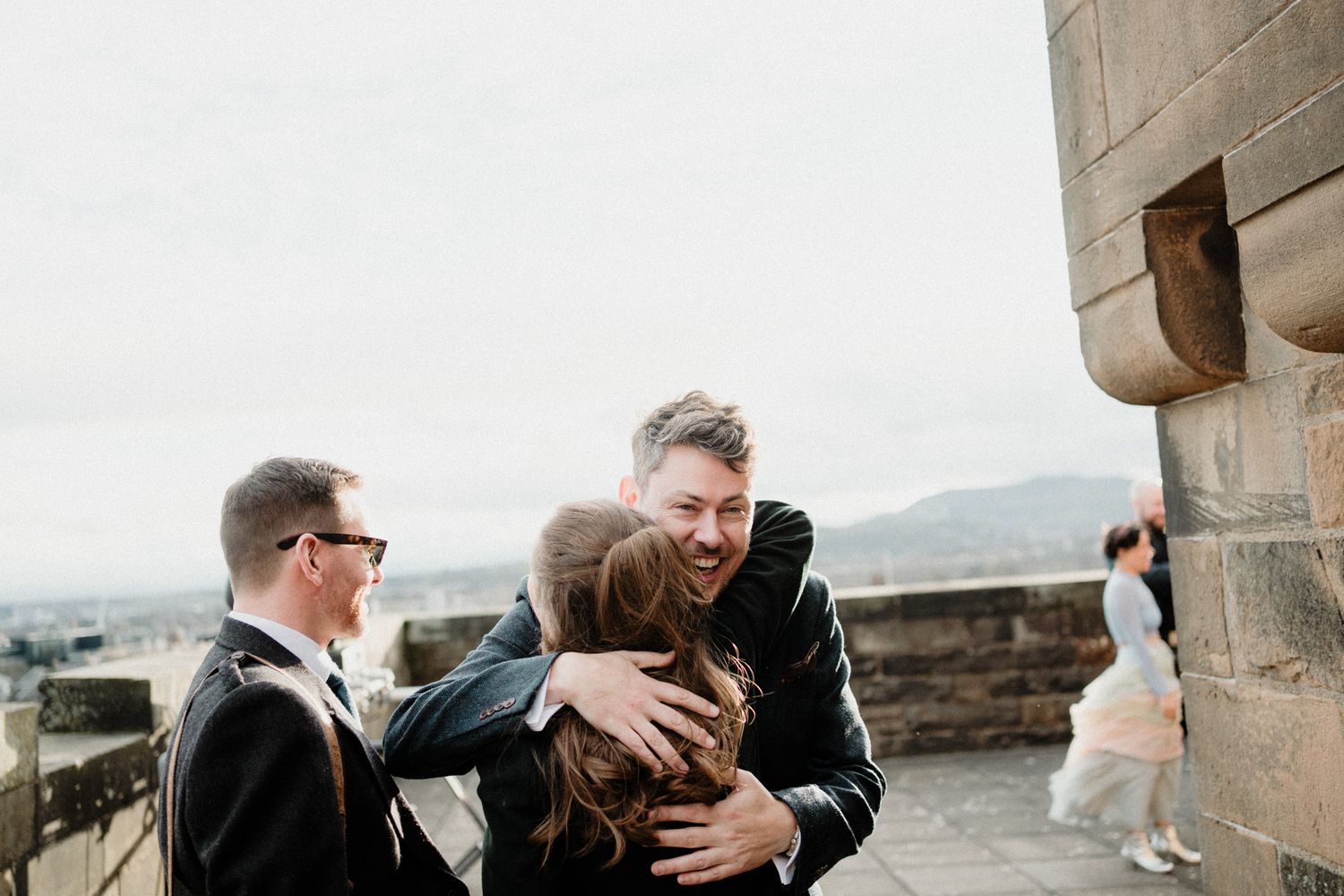 Intimate wedding moments captured against historic stone architecture.