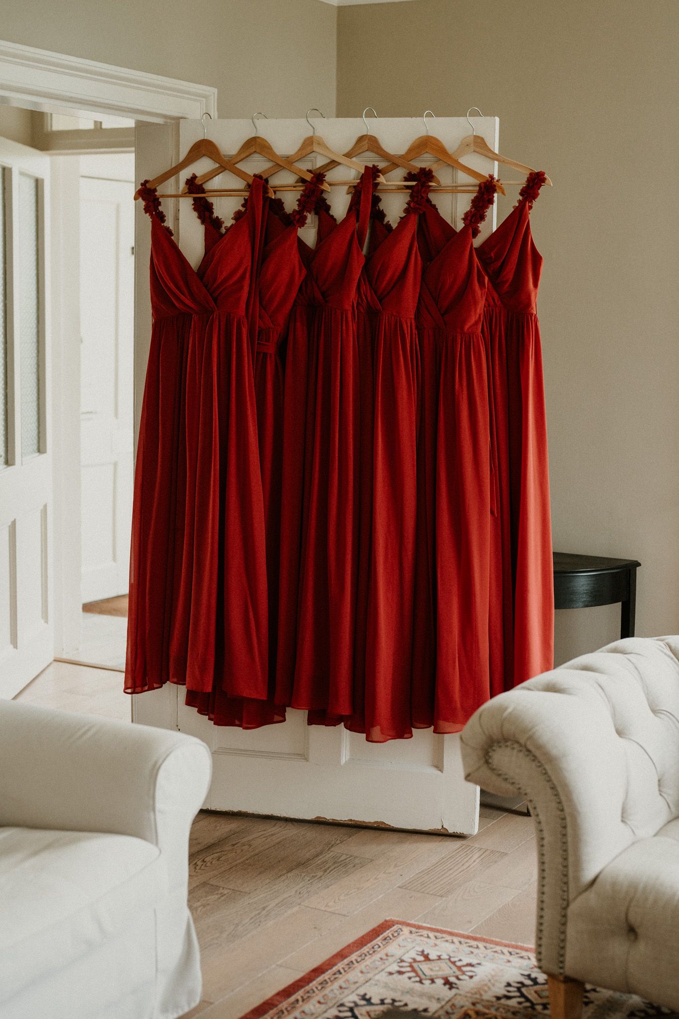 Red curtains hang elegantly against white walls in a bright interior room setting.