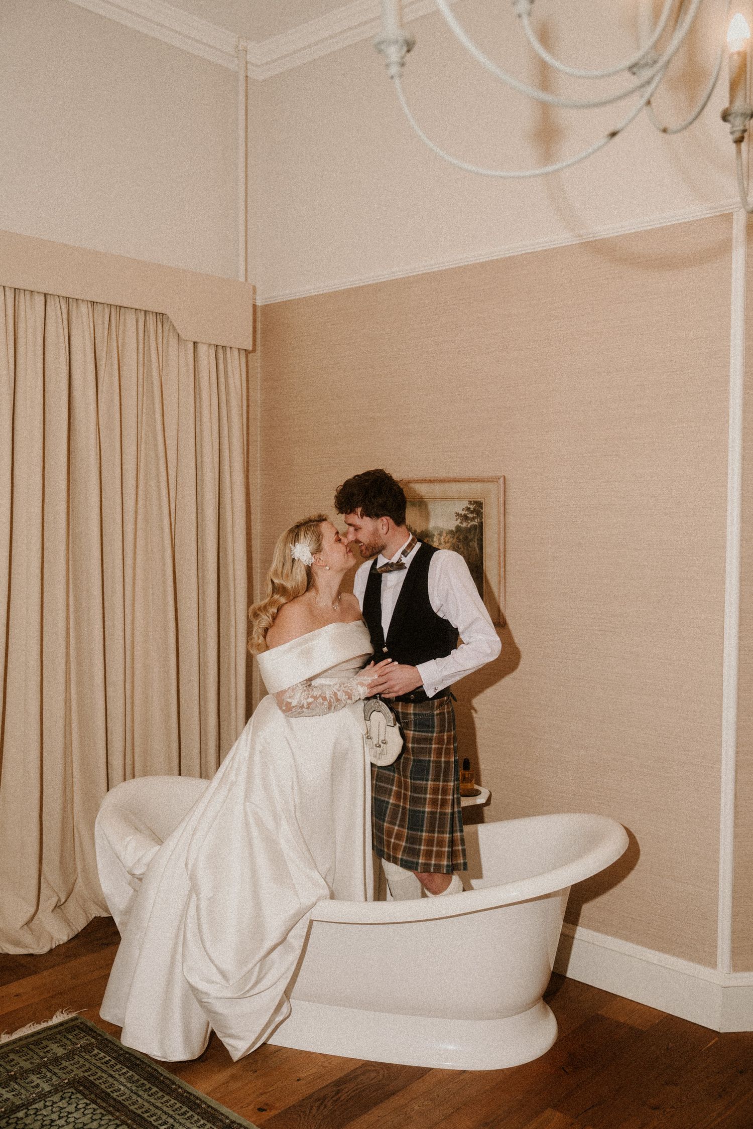 Romantic wedding photo series featuring a couple posing near a vintage white chaise lounge.