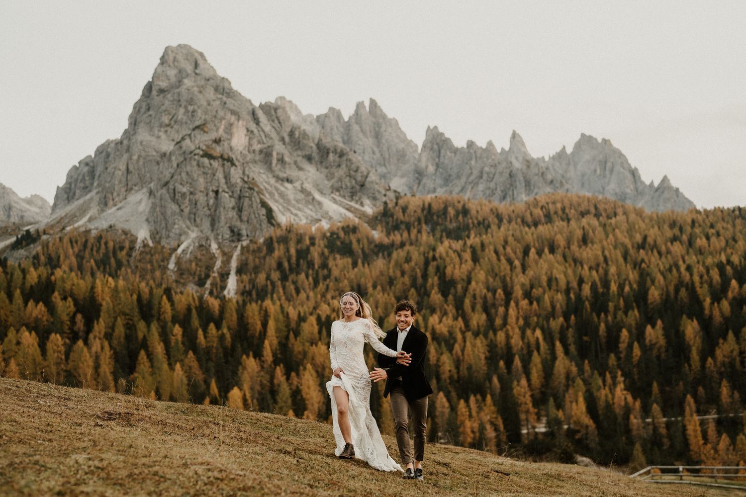 Romantic mountain elopement scene with dramatic peaks and autumn colors in the background.